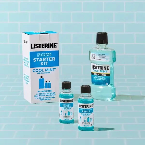 A Starter Pack of Cool Mint Zero Concentrate that includes 2 small refill bottles and a bottle of Listerine Cool Mint Zero is shown on a powder blue tile background