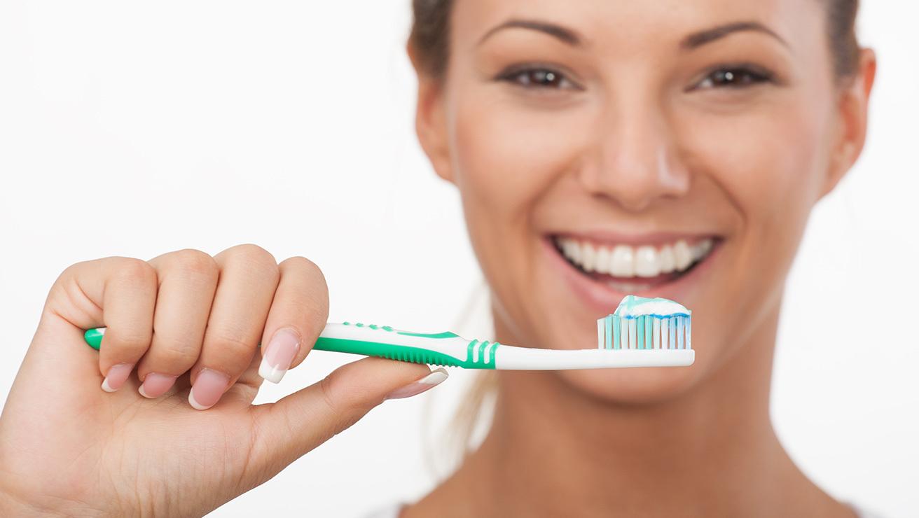 woman with toothbrush & toothpaste