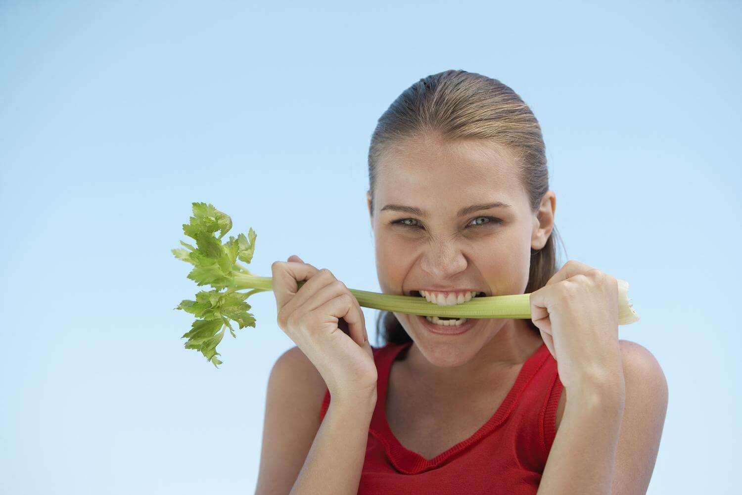girl biting celery