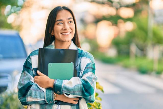 Woman with folders smiling