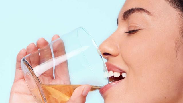 Woman smiling with mouthwash