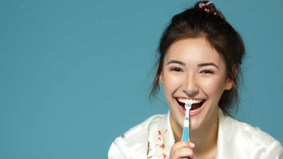 Woman smiling with toothbrush