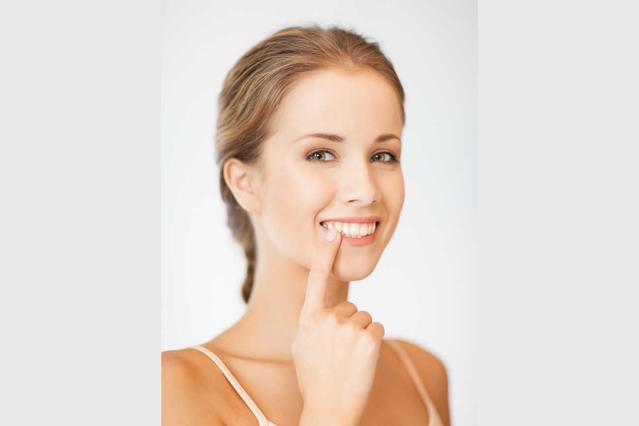 Woman pointing at white teeth