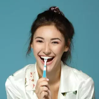 Woman smiling with toothbrush